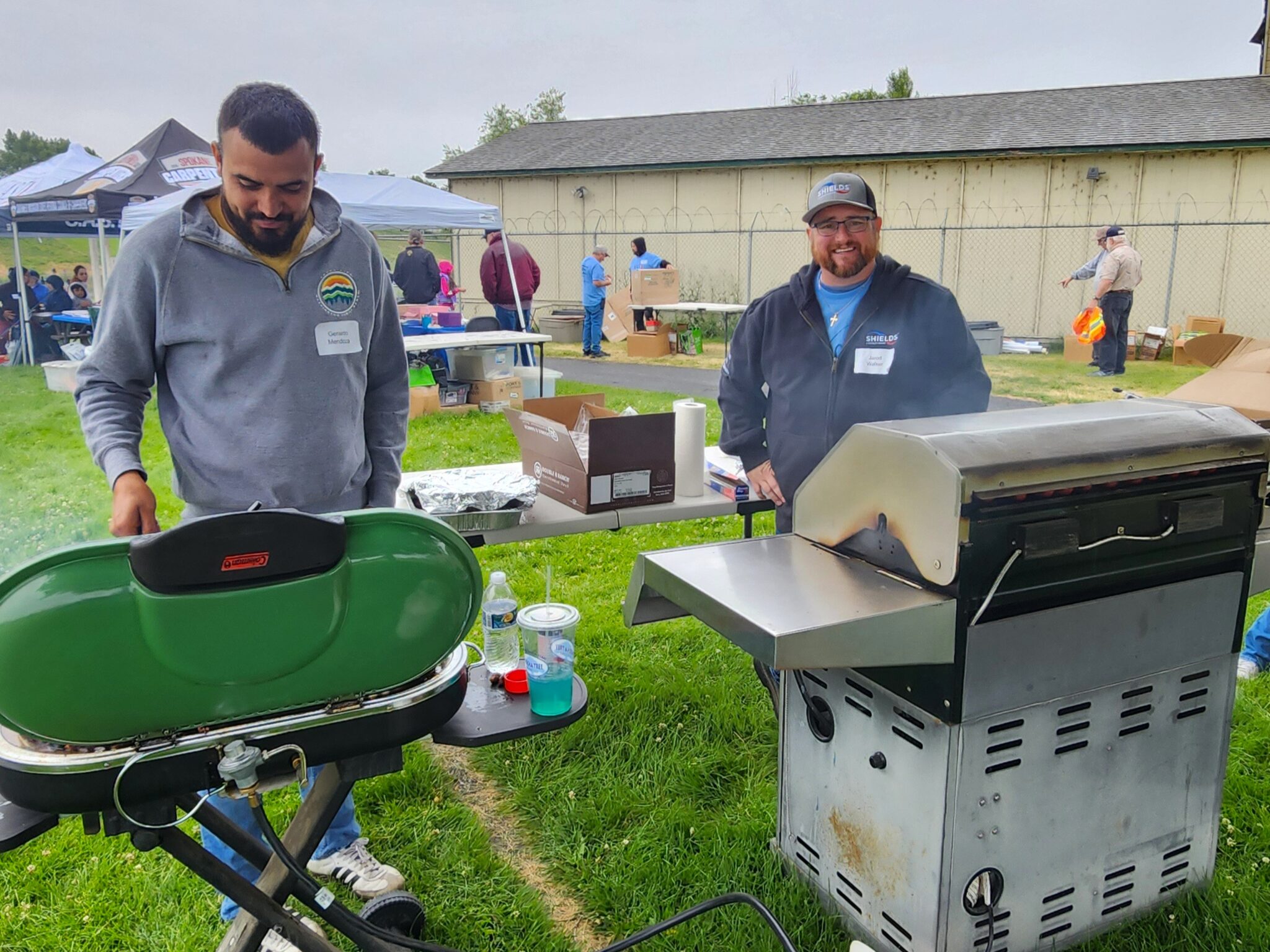 two adults grilling food at sarg hubbard pond