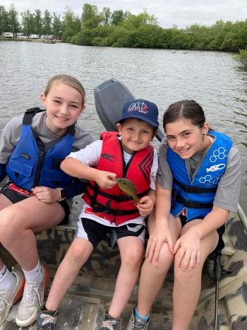 Greene County 4 boy holding a fish with a life jacket on