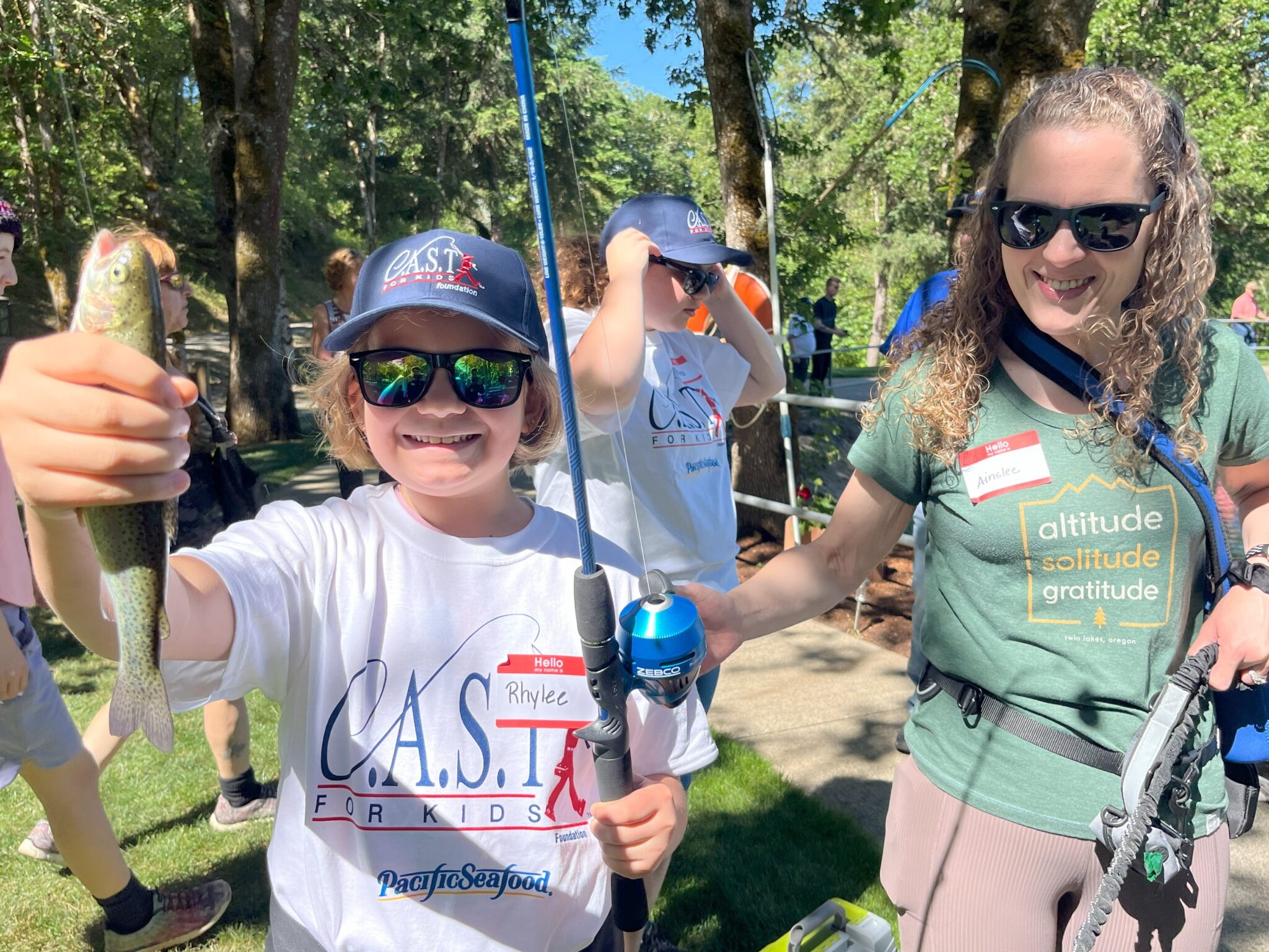 25BowmanPond1 child with blue fishing pole holding fish
