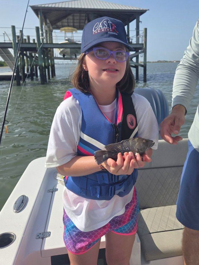 25StJohnsCounty1 young child holding fish at st johns county