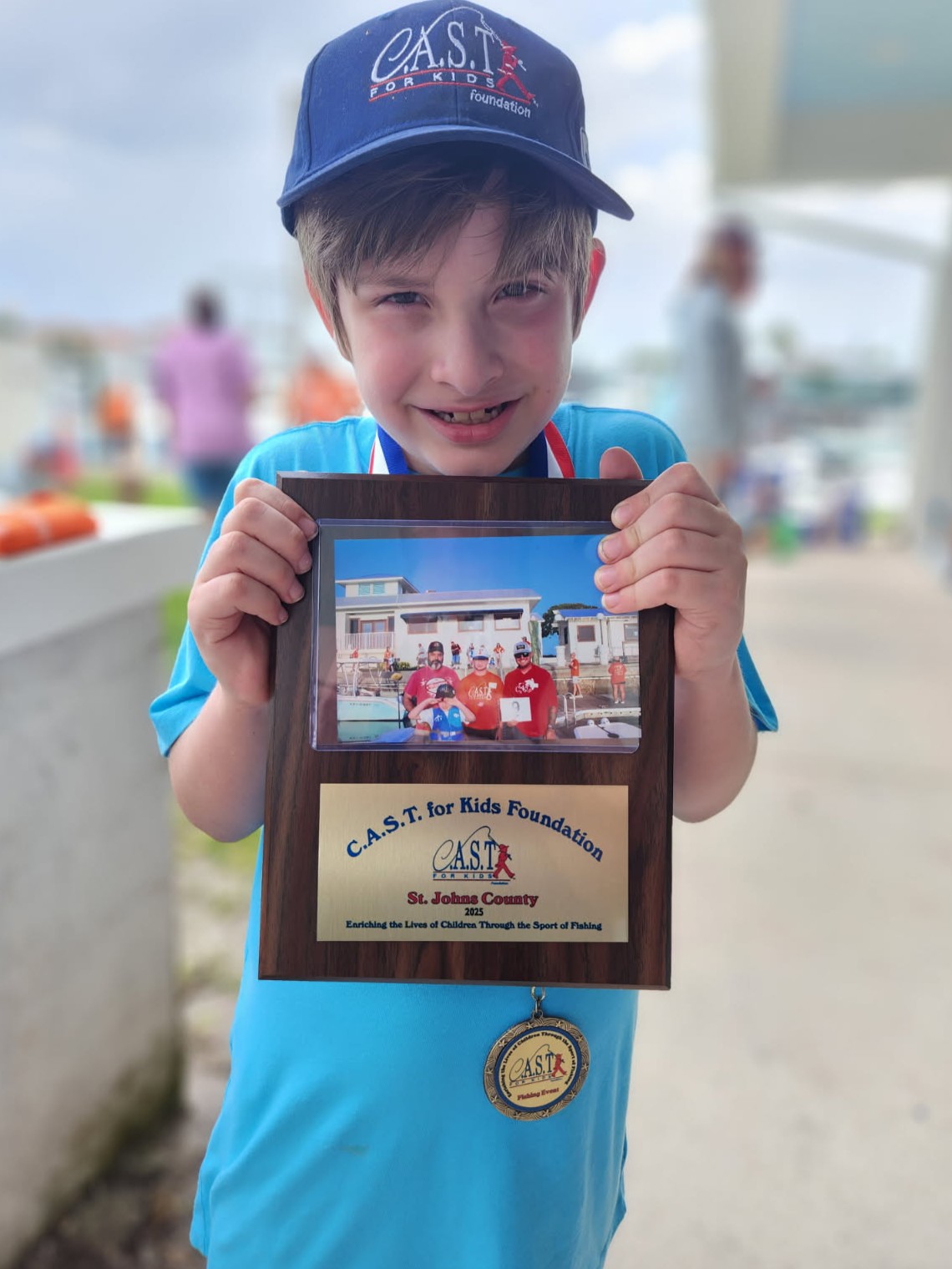 young boy holding plaque at st johns county