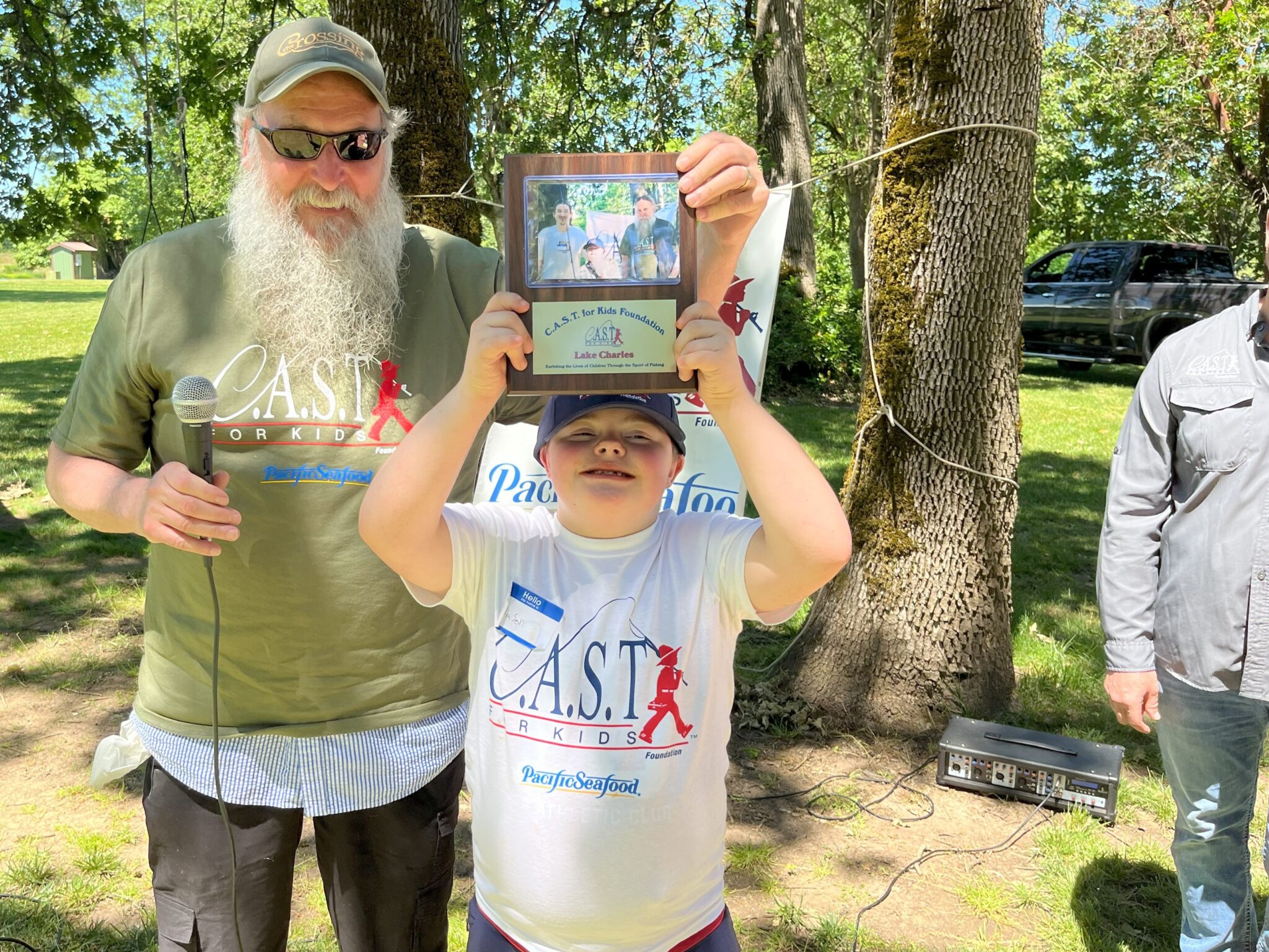 25LakeCharles4 young boy showing plaque at lake charles