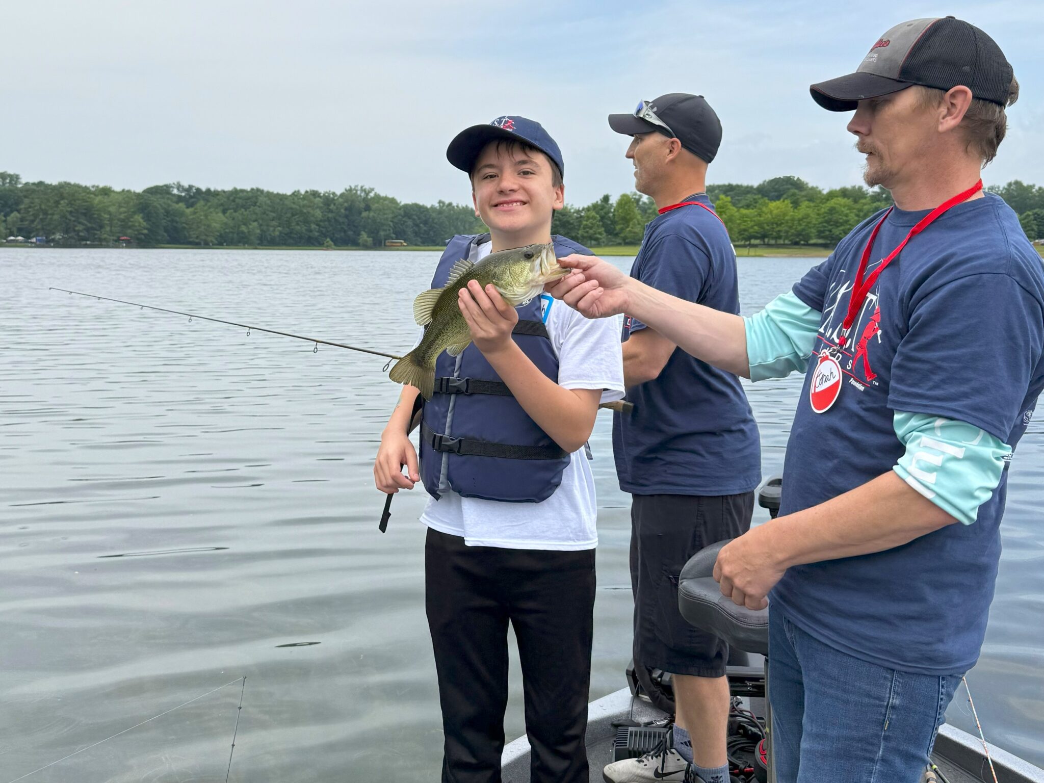25BigSevenLake1 three participants on boat at big seven lake