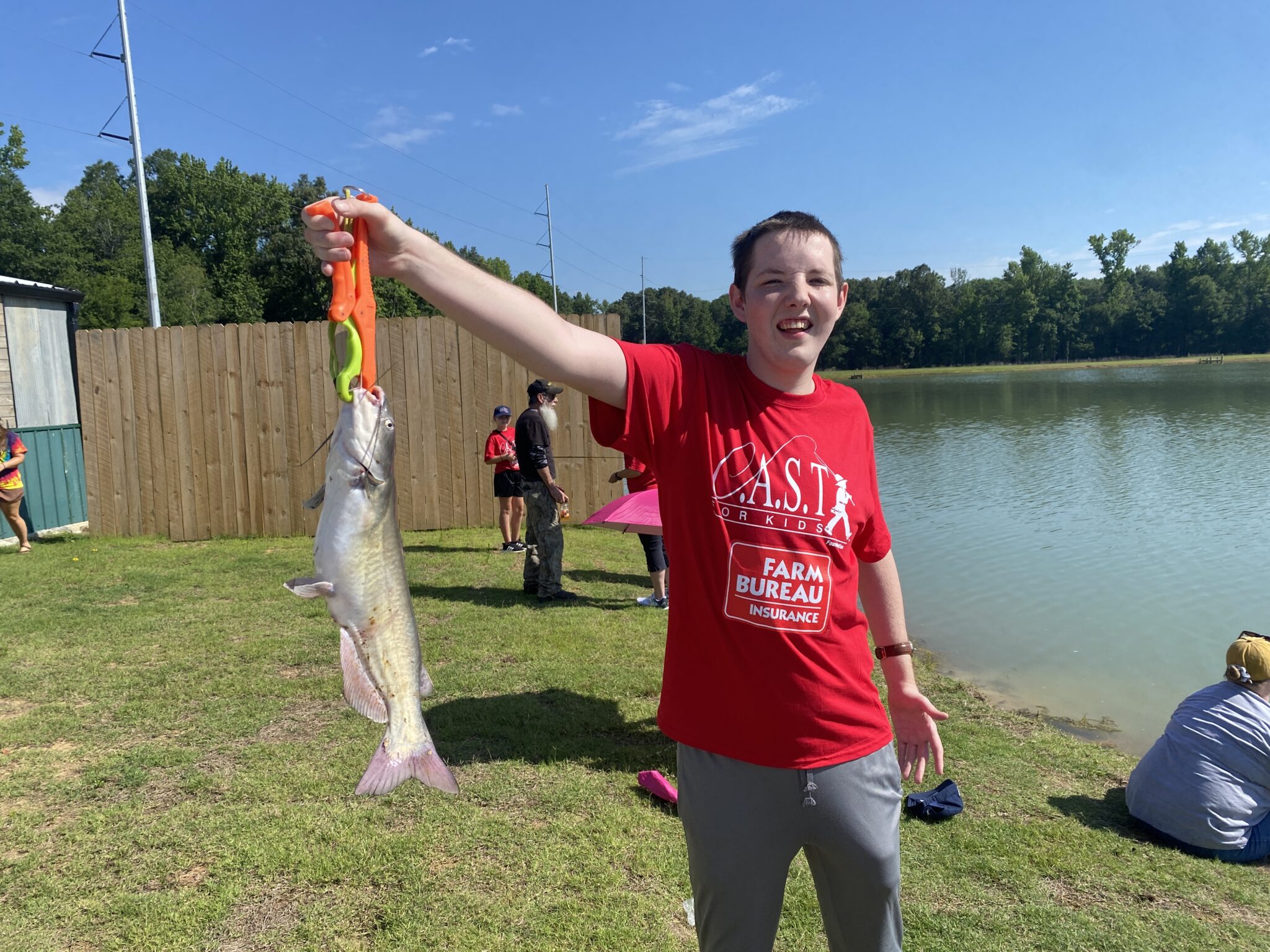 participants showing fish at CC by the lake