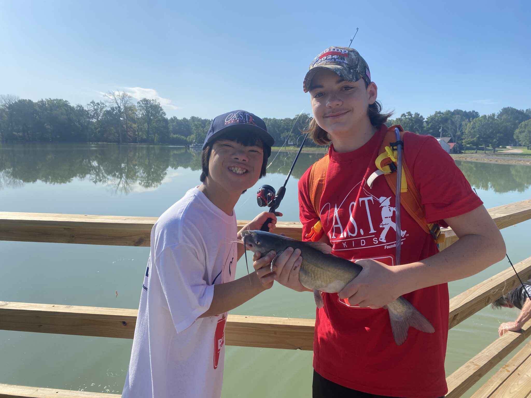 two participants showing fish at CC by the lake