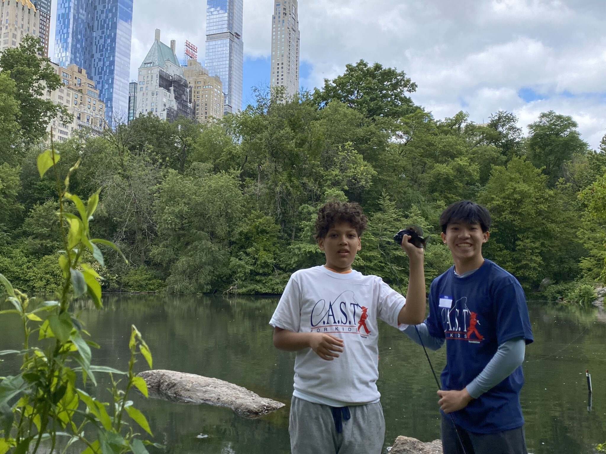 CentralParkPond2 two participants holding fish at central lake pond