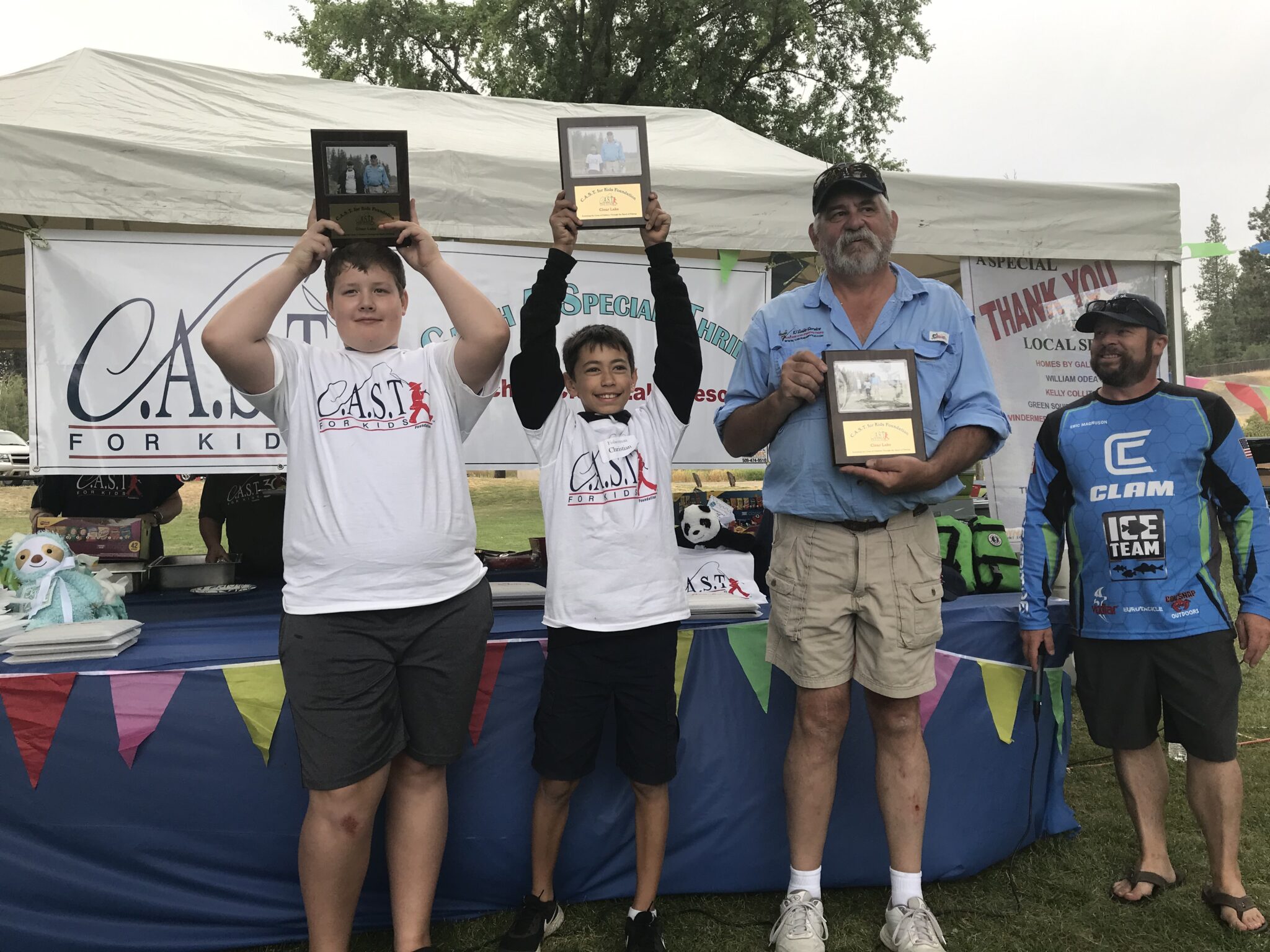 four participants holding plaques at clear lake