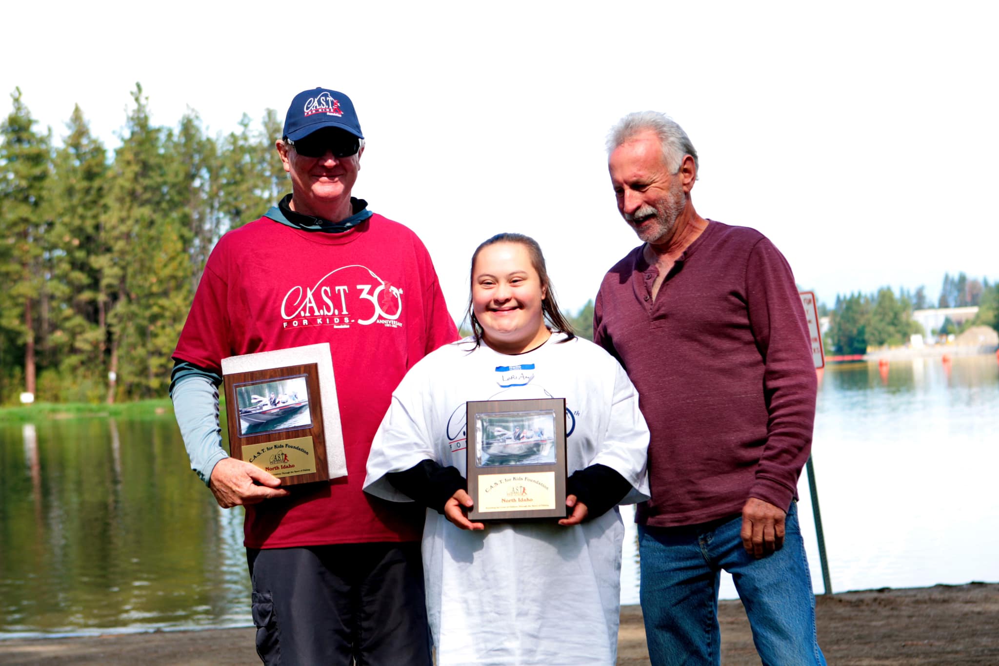Lake Coeur D'Alene2 three people holding plaques at Lake Coeur D'Alene