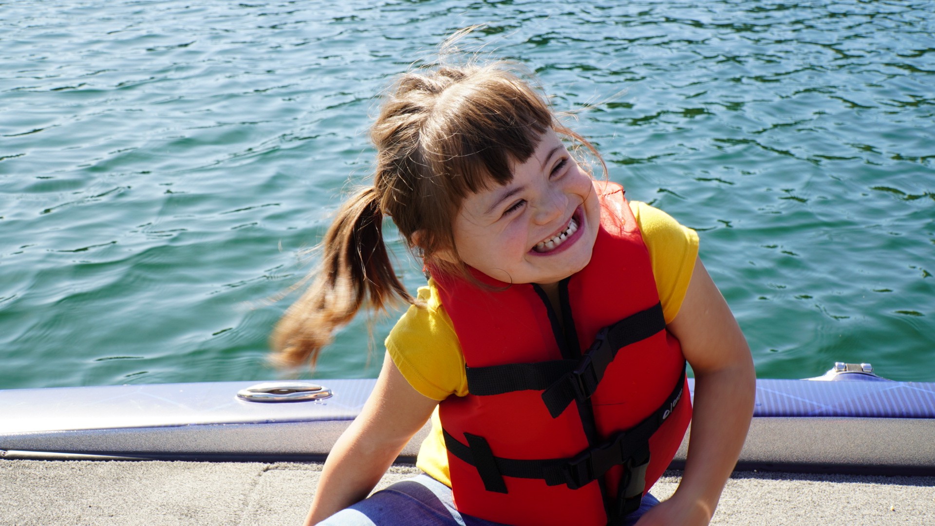 Lake Coeur D'Alene3 young girl laughing at Lake Coeur D'Alene