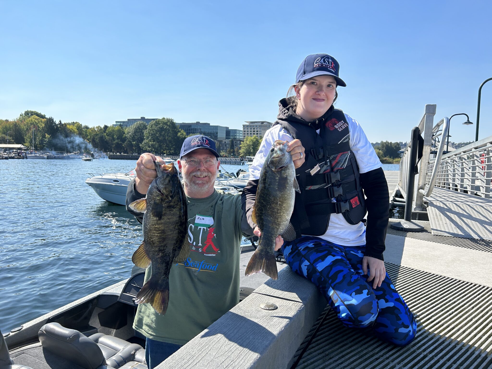 Lake Washington 1 participant holding 2 fish at Lake Washington
