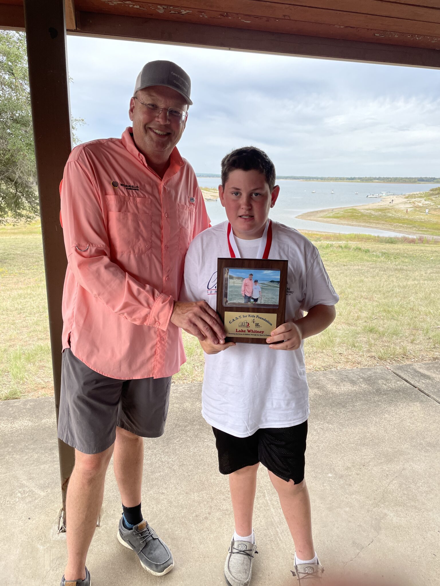 Lake Whitney 4 boy holding plaque at Lake Whitney