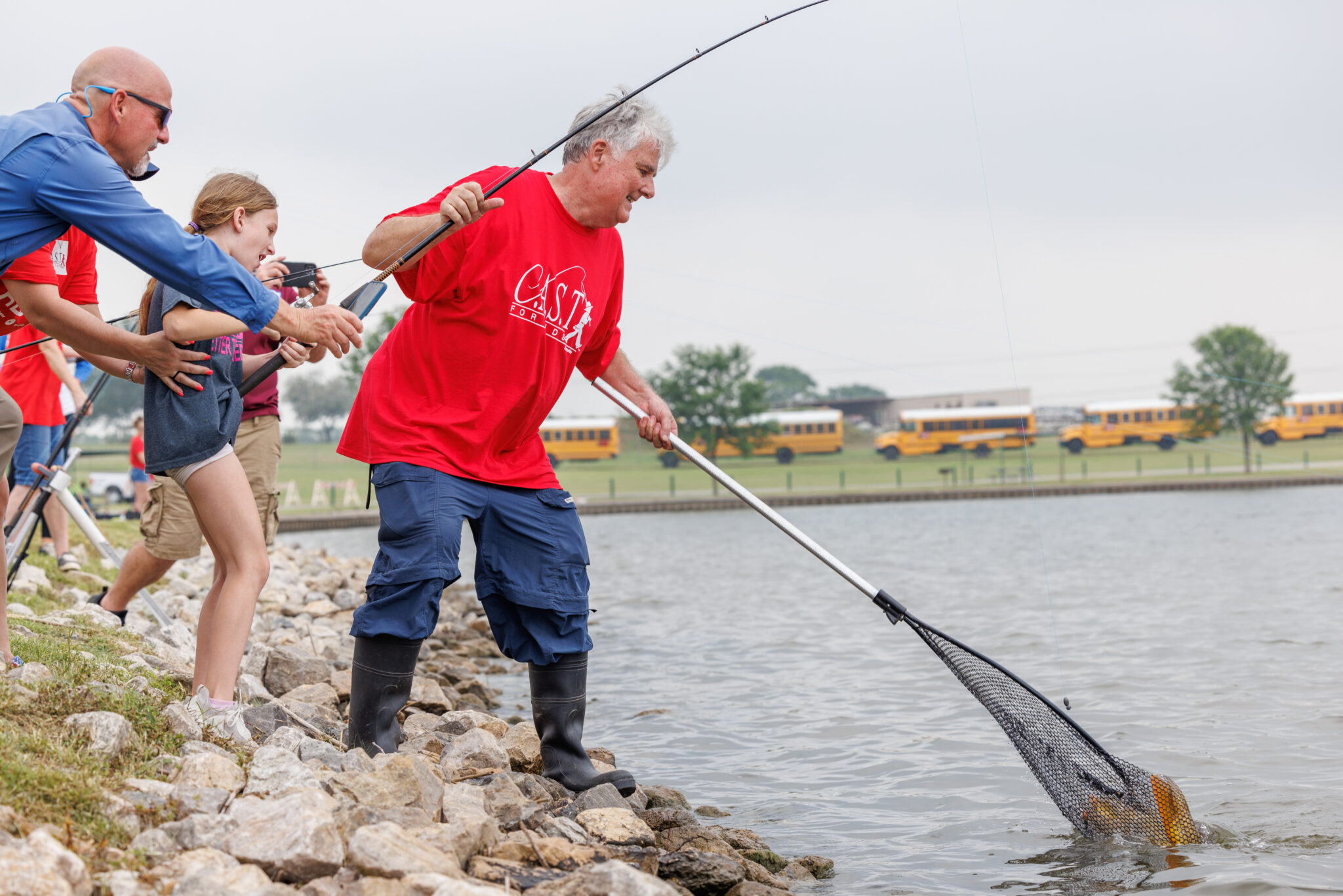 Planned Giving participants getting fish from the shore