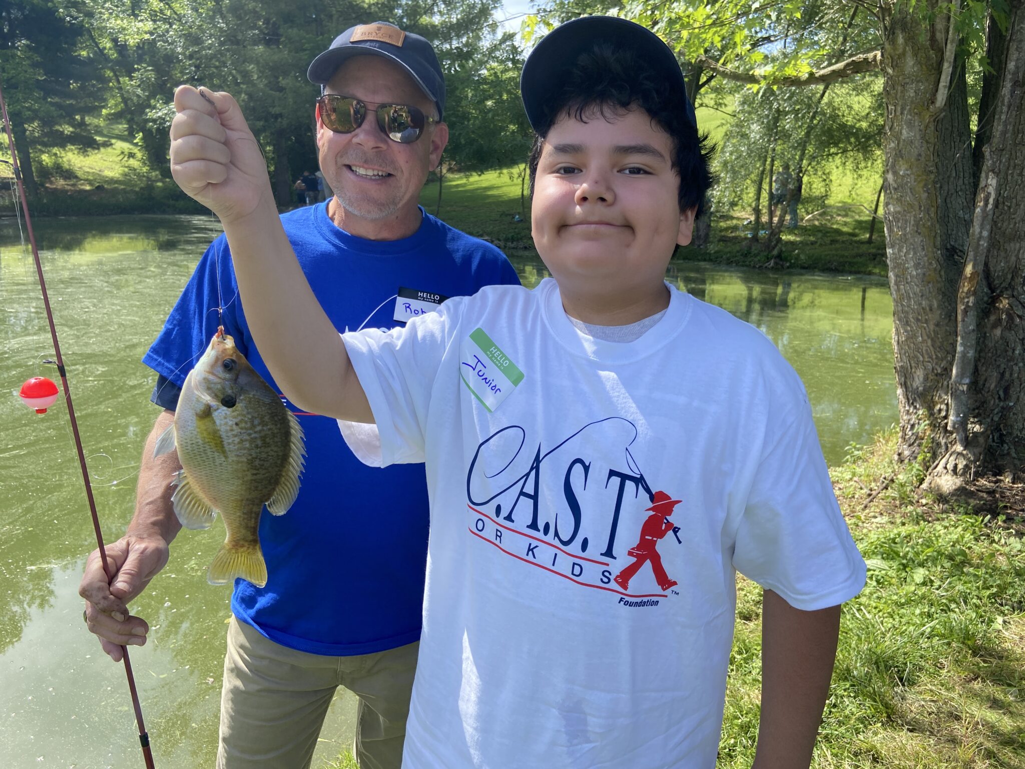 young boy participant holding fish at Spotted Dog Inn