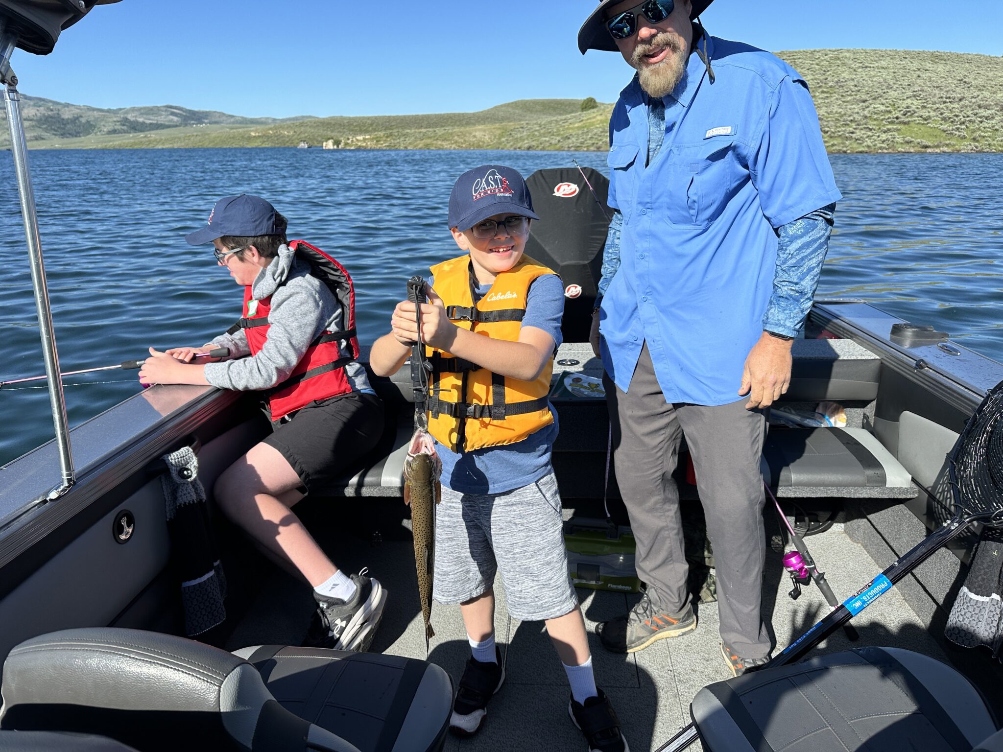 Strawberry Reservoir4 2 participants and an adult fishing on boat at strawberry reservoir