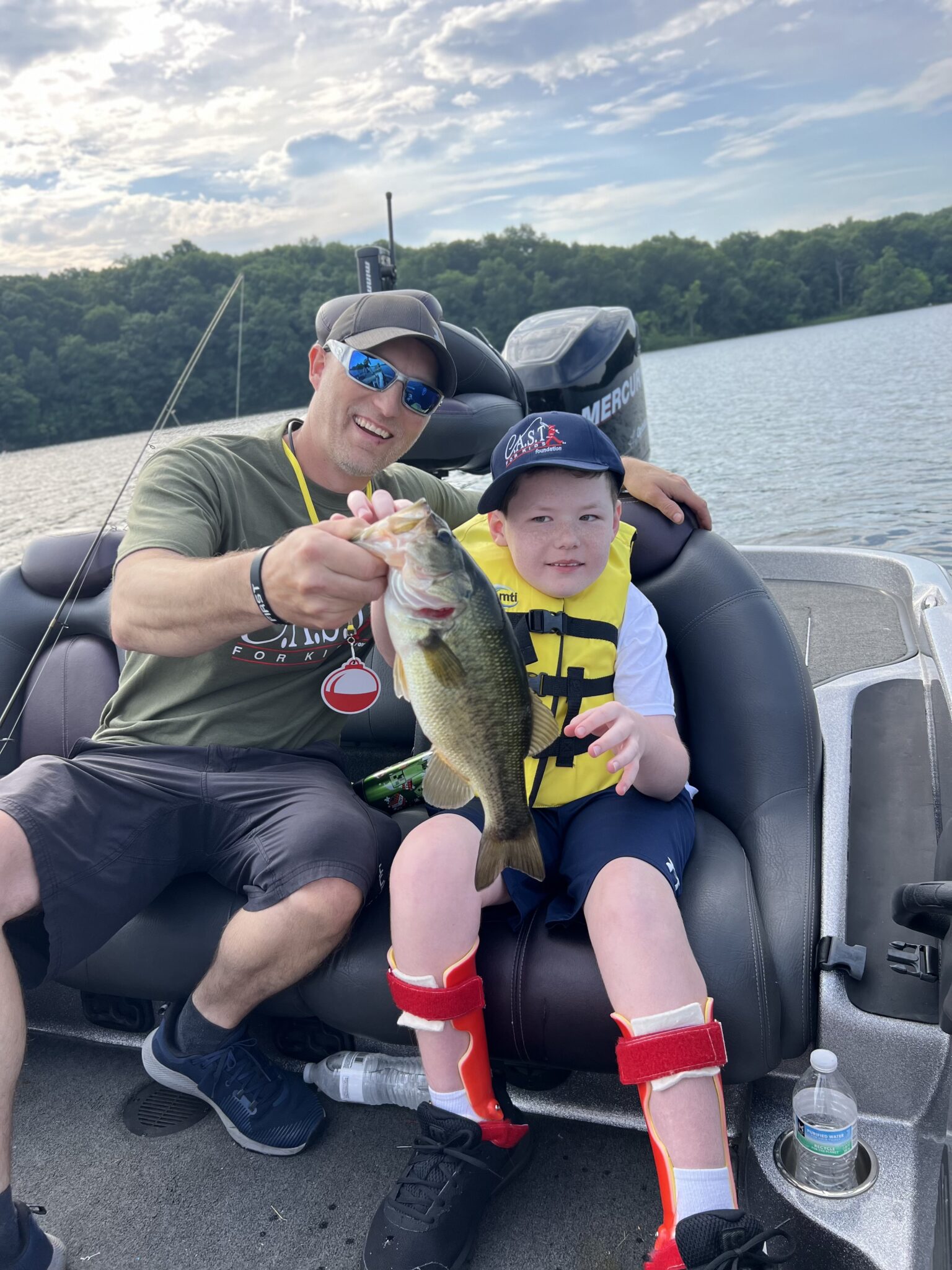 vol boat pic vol page boater volunteer with a fish and participant
