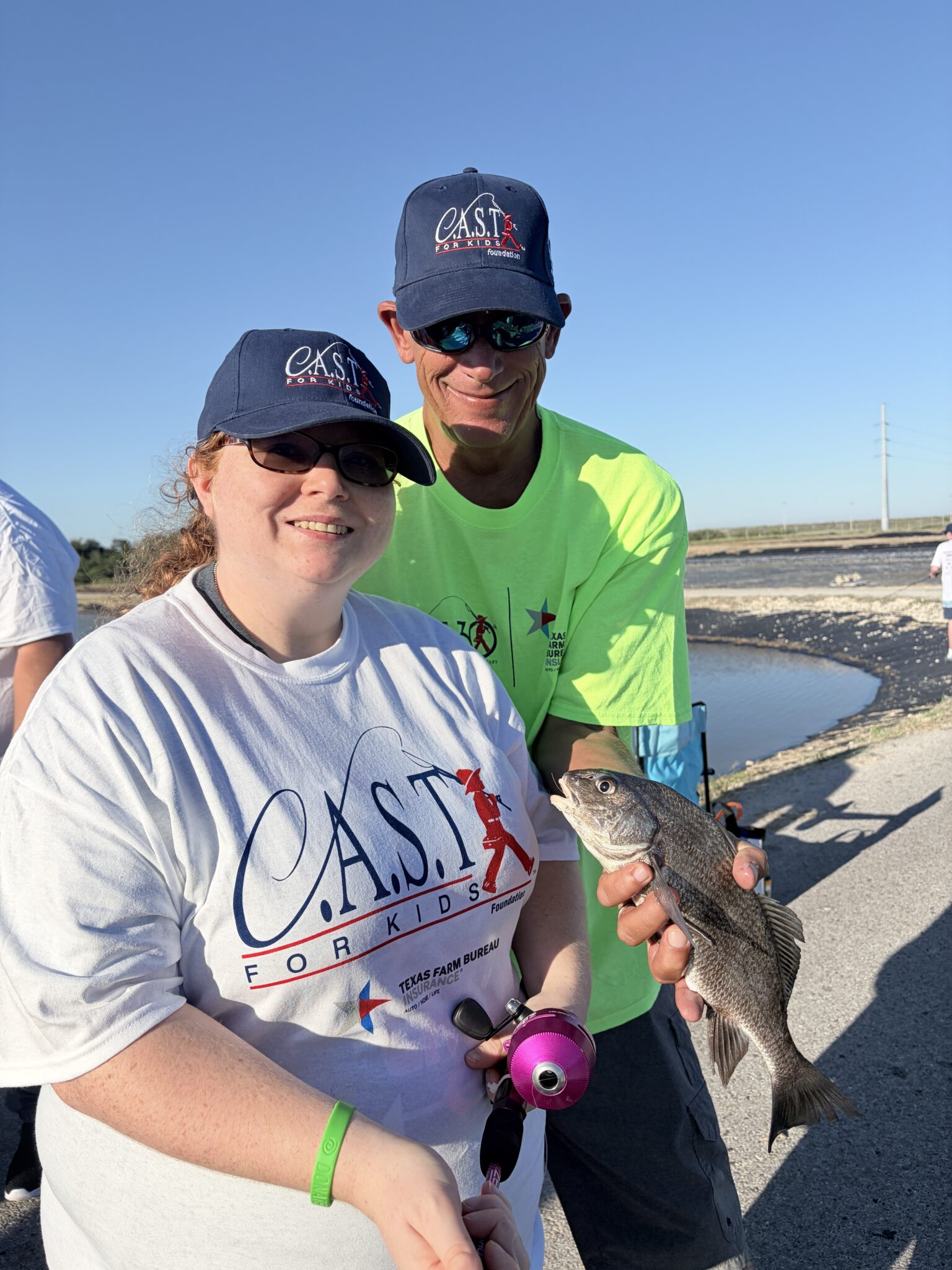 participant holding fish at TPWD Hatchery Flour Bluff