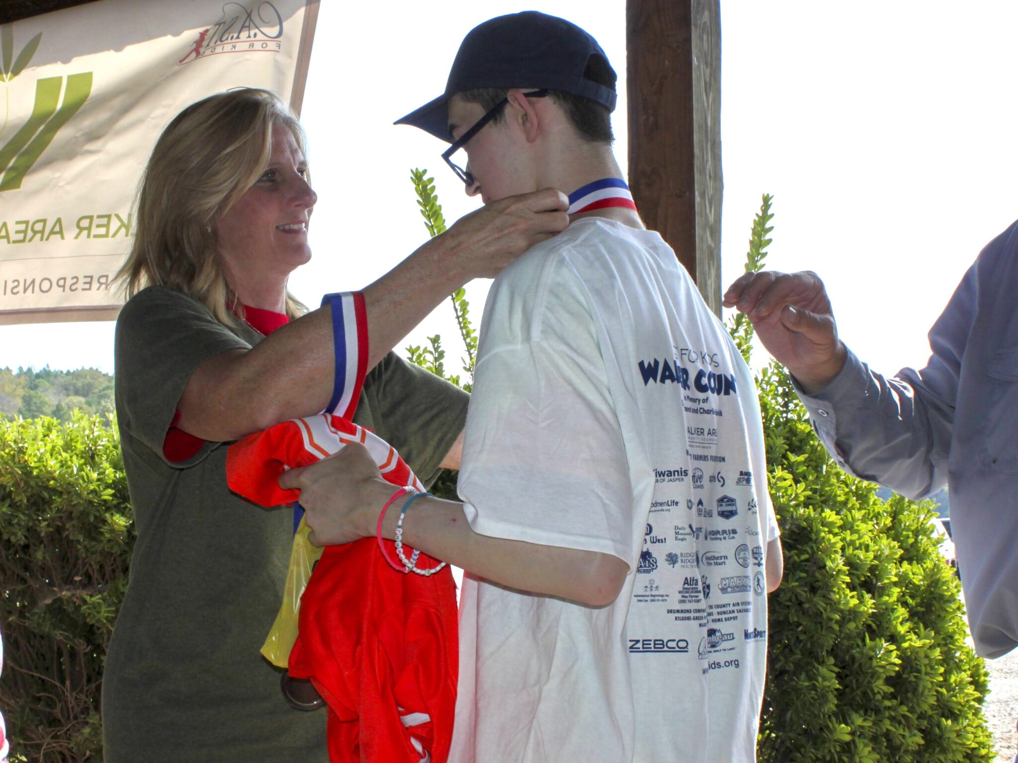 three participants showing off fish at Walker County Lake
